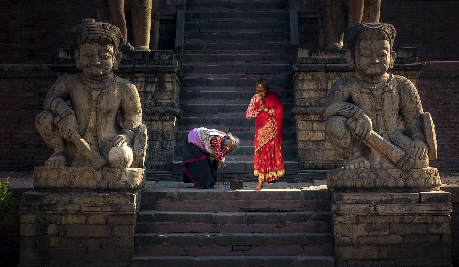 Believers under the Statue Believers under the Statue